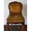 An amazing and unusual antique Mahogany bar chair with long legs and a mustard colour upholstery!!