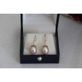 A stunning pair of pink Japanese Akoya pearl earrings with 9ct gold hooks in its original gift box