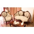 An elegant hand carved Victorian arm chair with gorgeous new fabric.