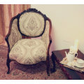 An elegant hand carved Victorian arm chair with gorgeous new fabric.
