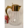 A spectacular lead crystal water jug with a cooler for ice, brass lid and handle in good condition
