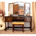 An exquisite three-drawer Imbuia dressing table with side-folding mirrors and a stool