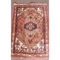 An awesome vintage/ antique? hand dyed Persian carpet (127cm x 80cm) with red and earthy tones