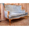 2 beautiful, elegant carved Victorian sofas with deep button detailing and blue period style fabric.