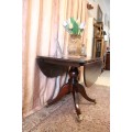 A fabulous stylish vintage drop leaf occasional table with ornate brass capped feet on castors