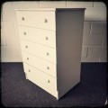 A lovely white veneer 5-drawer chest of drawers in good condition - perfect for extra packing space