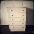 A lovely white veneer 5-drawer chest of drawers in good condition - perfect for extra packing space