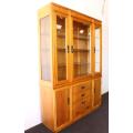 **RS17** A tall 3-door oak display cabinet with lighting, four drawers and two storage cupboards