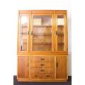 **RS17** A tall 3-door oak display cabinet with lighting, four drawers and two storage cupboards