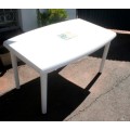 A sturdy white plastic six seater table perfect for a garden, patio/ lapa etc