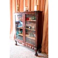 A beautifully made vintage solid Imbuia ball & claw two glass door showcase/ bookcase
