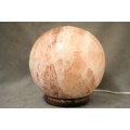An amazing Himalayan Crystal Salt lamp on a wooden base in complete working condition