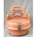 A fabulous large antique Chinese wooden lidded food pot with a decorative handle.