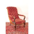 A stunningly hand carved antique walnut "Art Nouveau" reading chair with deep button detailing