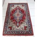 A stunning 95cm x 153cm hand knotted thick pile Persian carpet in dark reds. Gorgeous in all rooms!