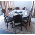A wonderful solid Imbuia dining suite with a large round table and 8 x upholstered chairs