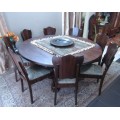 A wonderful solid Imbuia dining suite with a large round table and 8 x upholstered chairs