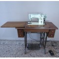 A remarkable vintage (1956-1961) Singer oak & cast iron stand with a 319K model sewing machine in