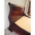 A stylish modern Coricraft Mahogany Queen sleigh bed with an Exotic pillow top mattress