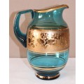 A unique set of matching cups with a jug decorated with gold gilt, perfect for entertaining guests.