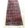 A stylish Hossenabad Persian runner carpet (80cm x 397cm).