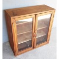 A solid Oregon pine cabinet with glass doors and wood shelves. Stunning in any home!!