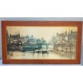 A large framed print of a town scene