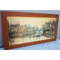 A large framed print of a town scene