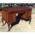 Very pretty, Stinkwood, Ball and Claw desk with five drawers and lovely linnenfold fronts.