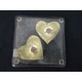 Glass coaster with brass hearts inside