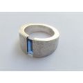 A thick heavy quality designer stamped sterling silver ring set with a faceted Sapphire