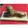 ANTIQUE SOLID BRONZE SPHINX ON WHITE MARBLE.