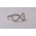 A VERY STYLISH SOLID STERLING SILVER ETERNITY SYMBOL RING WITH FANCY PATTERN