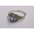 A BEAUTIFULLY DETAILED SOLID STERLING SILVER RING SET WITH A MARVELOUS FACETED BLUE STONE