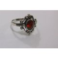 AN AWESOME SOLID STERLING SILVER RING WITH A STRIKING FACETED RED STONE ...MUST HAVE !!!