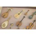 A vintage shadow box displaying miniature musical string instruments