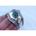 A vintage style solid sterling silver cuff bangle with cabochon green stone feature
