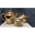 Unity teapot, sugar bowl, milk jug. Gilt with Victorian couple picture