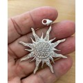 Silver plated sunburst pendant