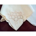 Four light beige tea cloths or coffee table cloths, delicate corner embroidery & scalloped edge