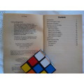 A Rubik's Cube plus a vintage book THE SIMPLE SOLUTION TO RUBIK'S CUBE