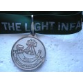 THE LIGHT INFANTRY MEDALLION ON A RIBBON IN VERY GOOD CONDITION