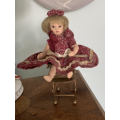Doll on metal high Chair