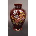 Beautil oriental vase made in Japan.  Floral design with gilt accents.  No chips or cracks