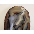 NATURAL AGATE SPECIMEN WITH A HIGHLY POLISHED OVAL SHAPED RECESSED INNER SECTION, WEIGHING 447 GRAM