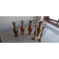A Collection Of Brass Jugs With Handles