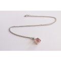 A STERLING SILVER NECKLACE WITH A FACETED PINK STONE SET STERLING SILVER PENDANT