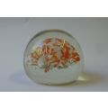 A COOL LOOKING VINTAGE SOLID GLASS PAPERWEIGHT WITH WHITE AND ORANGE SPECKLES DETAIL...NICE !!