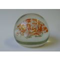 A COOL LOOKING VINTAGE SOLID GLASS PAPERWEIGHT WITH WHITE AND ORANGE SPECKLES DETAIL...NICE !!