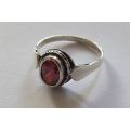 A Fancy Solid Sterling Silver ring set with a red faceted Cubic Zirconia !! No Combining Fees !!